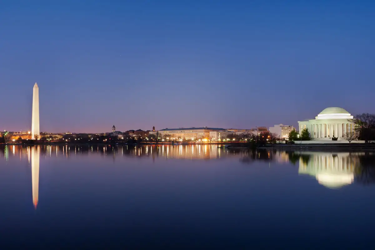 The Washington Monument and the Jefferson Memorial at dusk, reflected in the Tidal Basin.